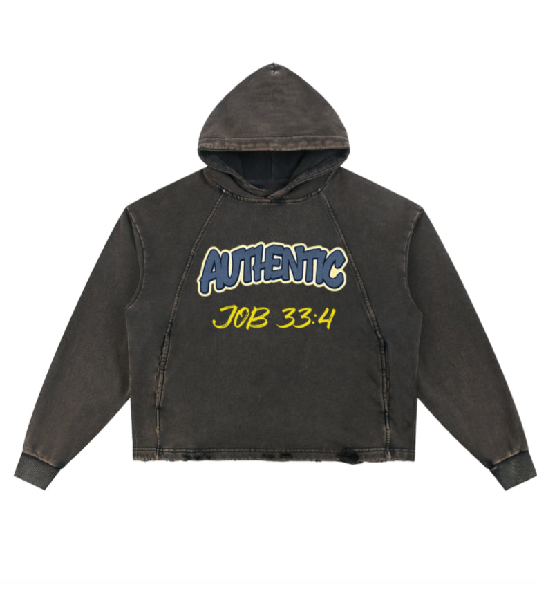 A washed black cropped hoodie with a distressed acid-wash finish, featuring a blue and yellow graphic on the chest that reads 'AUTHENTIC JOB 33:4'. The hoodie is displayed flat against a solid white background.