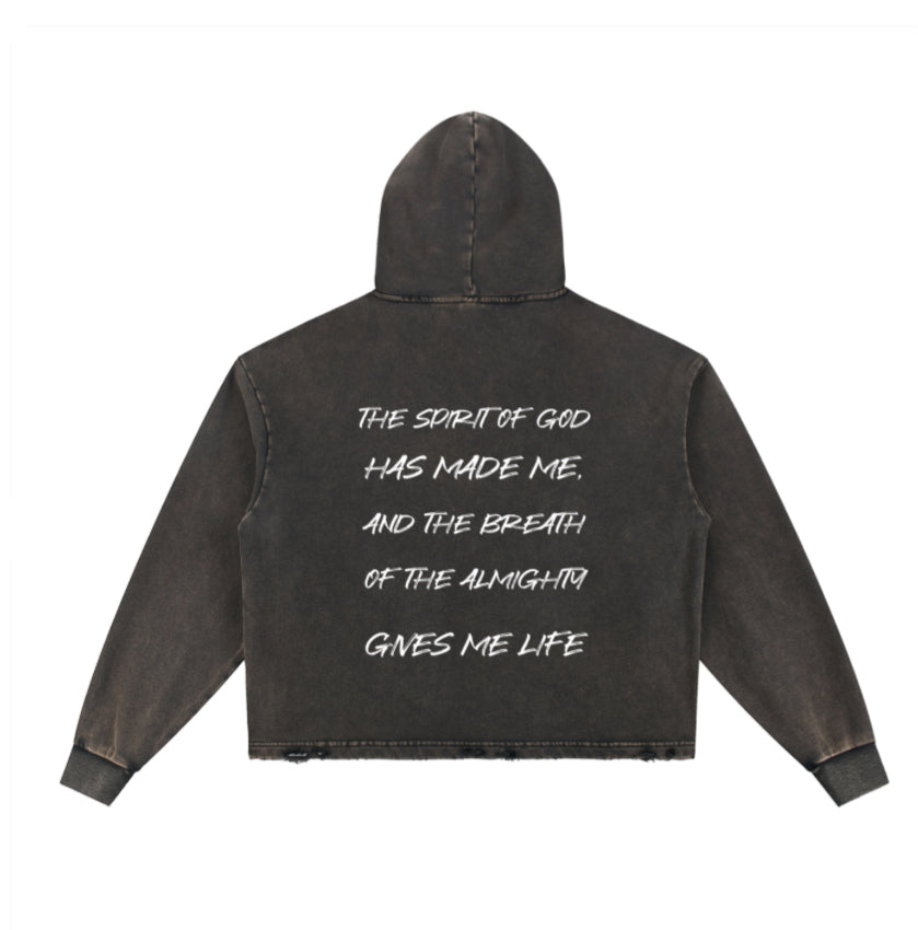 A washed black hooded sweatshirt shown from the back, featuring a white hand-written style text quote on the center back, displayed against a solid white background.